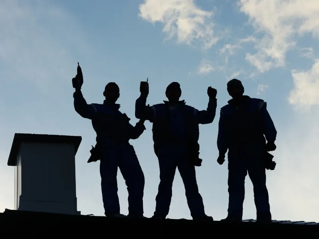 a group of roofing contractors standing on a roof